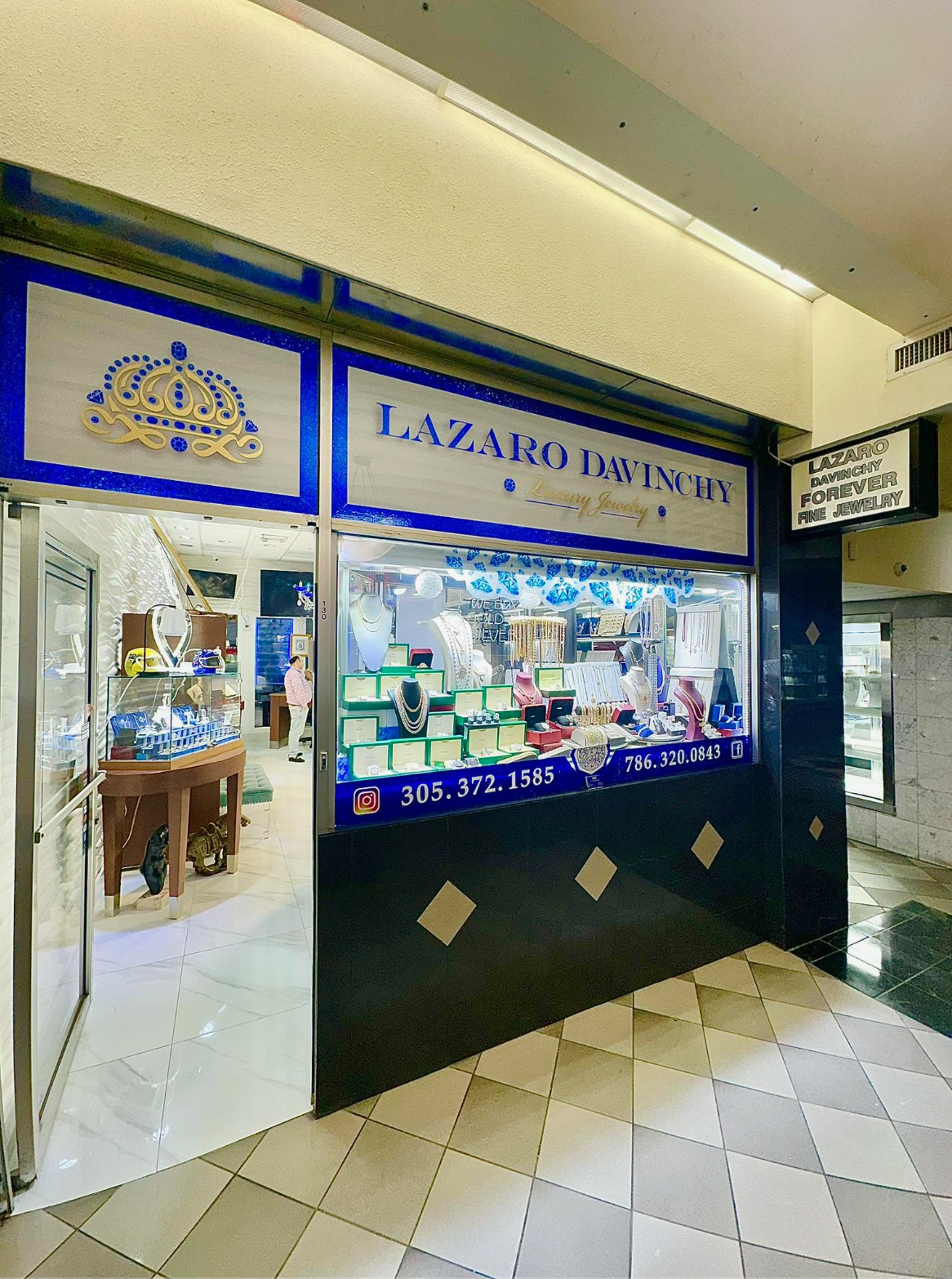 Lazaro Davinchy storefront in the Seybold Building with royal blue and gold crown signage